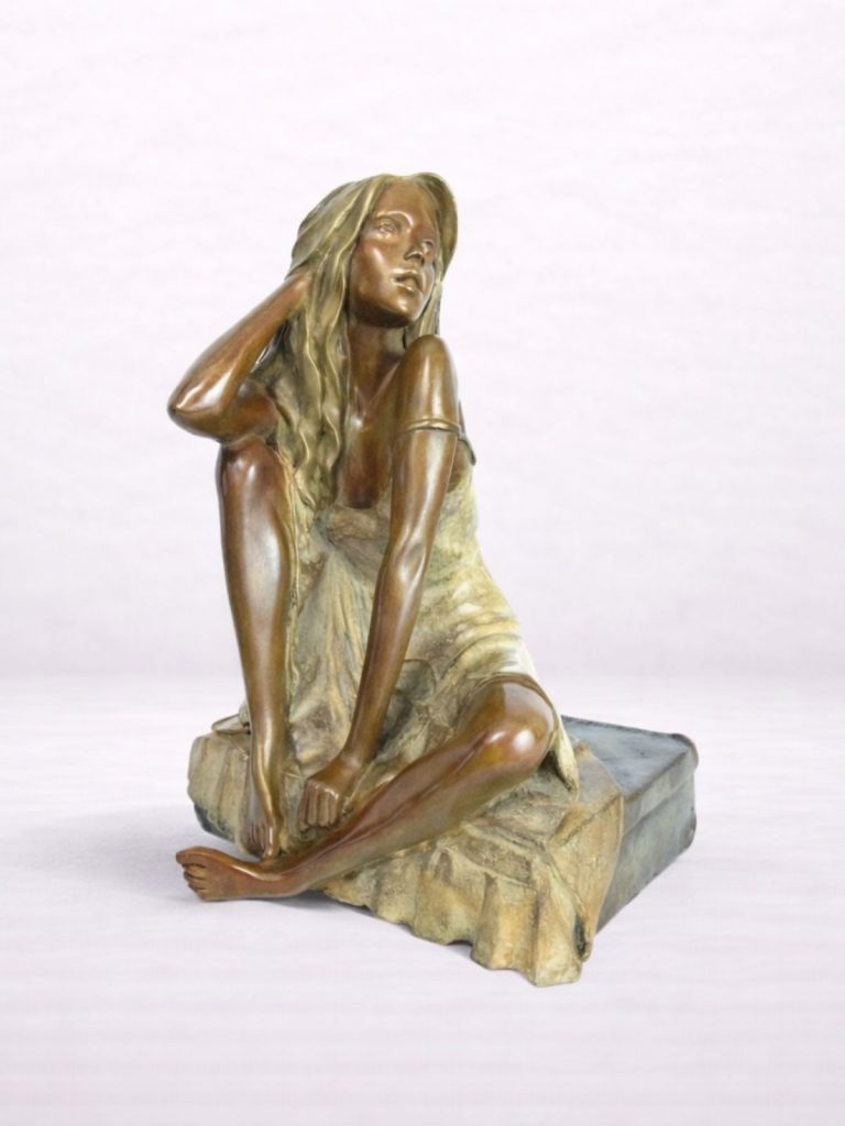 Sculpture en bronze d’une femme assise sur une valise, Une main dans les cheveux.